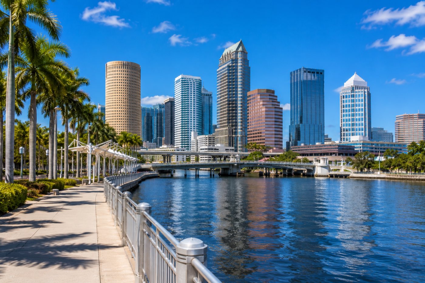 The Tampa Riverwalk and downtown Tampa skyline along the Hillsborough River at dusk