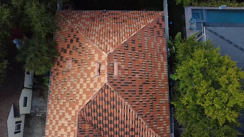 Overhead aerial view of a hip roof with orange-brown roofing