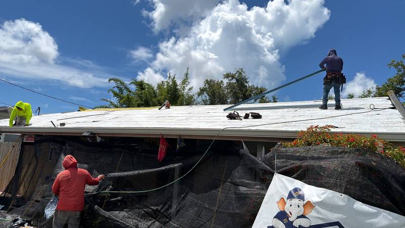 Redefine Roofing crew working on a roof deck during a project